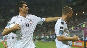 Germany's Podolski celebrates with Gomez after scoring a goal against Denmark during their Group B Euro 2012 soccer match at the New Lviv stadium in Lviv